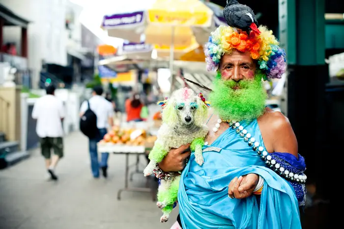 a colorfully dressed person at a parade in Jackson Heights